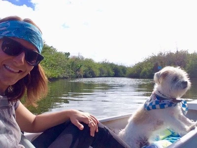 Girl in a kayak with a dog.