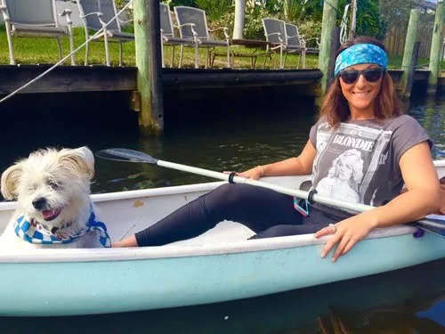 Girl on a kayak with her dog 