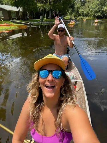 Women and man canoeing down river