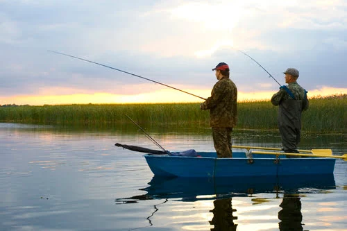 Two anglers fishing out of a rowboat
